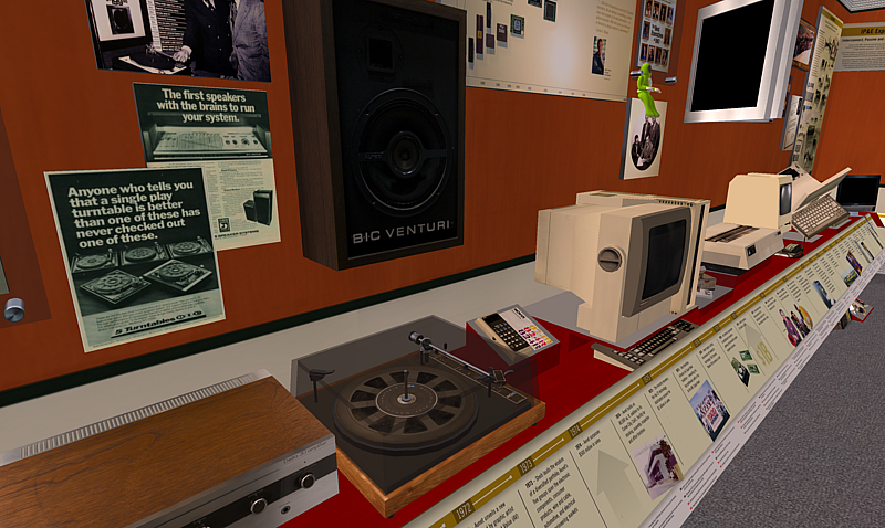 Detail view of the Avnet Technology Museum in Second Life showing 3D reproductions of vintage electronics including a BIC Venturi speaker, turntable, and early personal computer, with period advertisements and a historical timeline display along the exhibit wall.